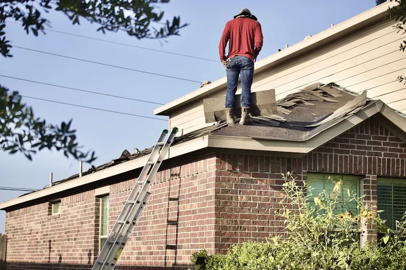 Professional roofer working on a residential roof in Westville Grove
